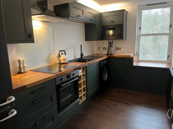 Glasgow kitchen installation with solid timber doors, walnut worktops, LED lighting