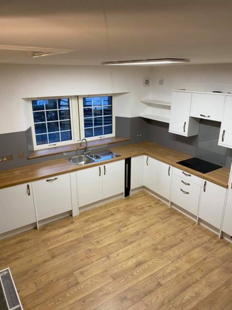 B&B kitchen installation Glasgow with white slab doors and oak flooring