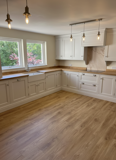 High-end bespoke kitchen installation Glasgow with painted doors and oak flooring